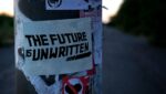 A sticker on a street pole that reads "The Future Is Unwritten" Photo by Mac Bohme - found on Unsplash.com